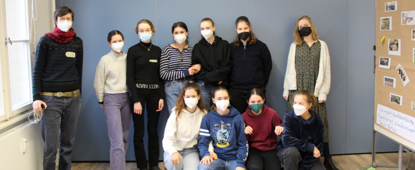 Gruppenfoto von 9 Mädchen und 2 Frauen, alle mit FFP2 Maske